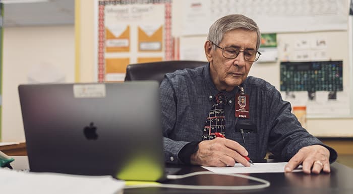 Pat Funk grading papers at Wiscasset school